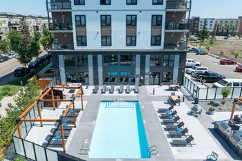A large building with a pool in front.
